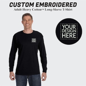May include: Black long-sleeve t-shirt with a space for custom embroidery. The text "YOUR DESIGN HERE" is displayed in a white box on the shirt and in a larger white box on a black circle.