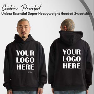 May include: A black hooded sweatshirt featuring the white text YOUR LOGO HERE on the front and back. The garment includes a hood, long sleeves, and a front pouch pocket. The text Custom Printed Unisex Essential Super Heavyweight Hooded Sweatshirt is visible.