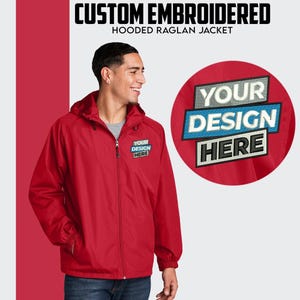 May include: Red hooded raglan jacket with a zipper closure and a pocket on the left chest. The jacket has the text "YOUR DESIGN HERE" embroidered on the chest.