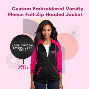 May include: A black fleece full-zip hooded jacket with pink sleeves and black and pink striped cuffs. The jacket has a  'YOUR CUSTOM EMBROIDERY HERE'  text on the left chest.