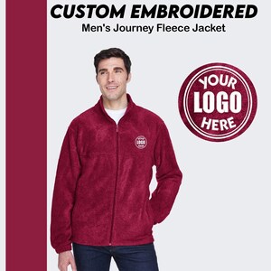 May include: Burgundy fleece jacket with a zipper closure and a small embroidered logo on the left chest. The text "YOUR LOGO HERE" is displayed in a circle on the right side of the image.