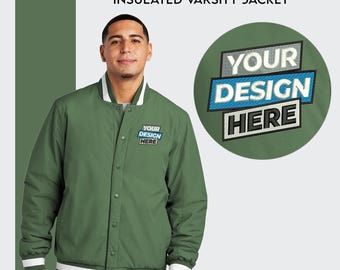 May include: A green insulated varsity jacket with white ribbed trim. The jacket has a button closure and two pockets. The jacket is embroidered with the text "YOUR DESIGN HERE" in a blue and gray font.