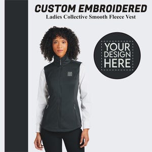 May include: Black fleece vest with a zipper closure and two pockets. The vest has a white embroidered logo that says "YOUR DESIGN HERE".