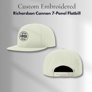 May include: A cream-colored Richardson Cannon 7-panel flatbill cap with a perforated side and back design. The front panel features a circular black embroidered logo with the text YOUR LOGO HERE. The back includes an adjustable snapback closure.