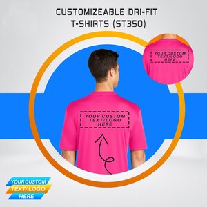 May include: A pink dri-fit t-shirt with the text "YOUR CUSTOM TEXT/LOGO HERE" printed on the back. The shirt is customizable with your own text or logo.