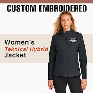 May include: Black Teknical Hybrid Jacket with the text "CUSTOM EMBROIDERED" at the top. The jacket has a quilted front and smooth sleeves. The text "CUSTOM EMBROIDERY HERE" is on the right chest. The text "Women's Teknical Hybrid Jacket" is on the left.