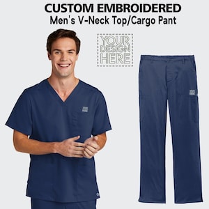May include: A navy blue V-neck top and matching cargo pants. Both items have a pocket on the left side with the text "YOUR DESIGN HERE" embroidered on them.