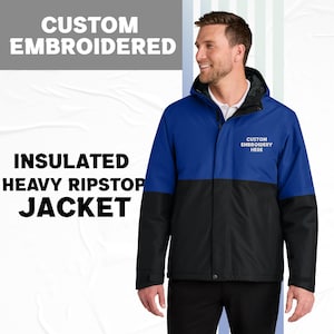May include: A blue and black insulated heavy ripstop jacket with a hood. The jacket has the words "CUSTOM EMBROIDERED" at the top and "CUSTOM EMBROIDERY HERE" on the chest. The jacket is worn by a person.