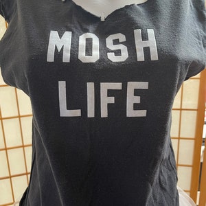 May include: Black sleeveless shirt with a white graphic that says "MOSH LIFE".