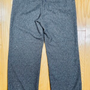 May include: Gray cuffed pants with a textured woven fabric.