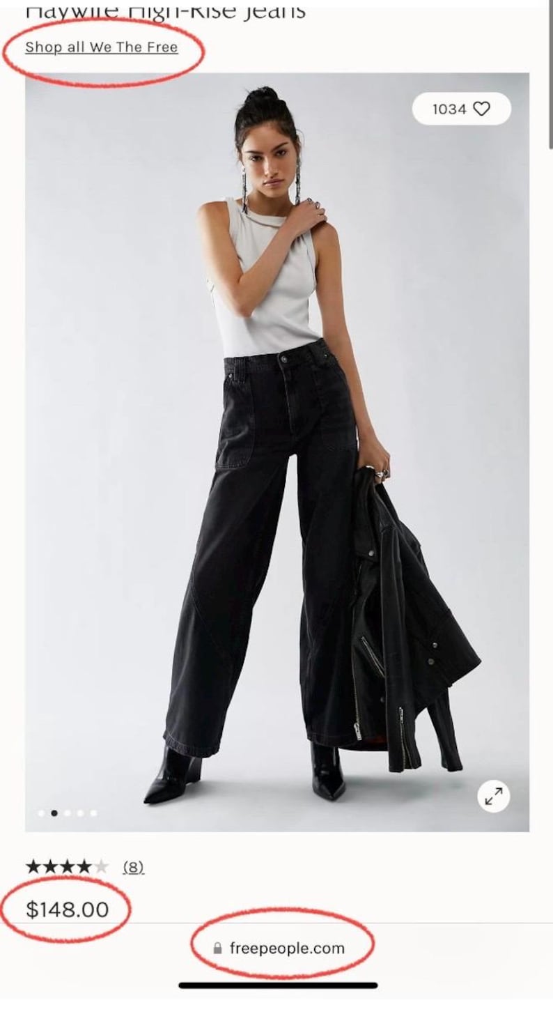 May include: A woman wearing a white tank top and black high-rise jeans, holding a black jacket. The image is from the brand "We The Free". The jeans have large pockets. The model is wearing black boots.