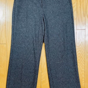 May include: Gray wide-leg pants with a cuffed hem.