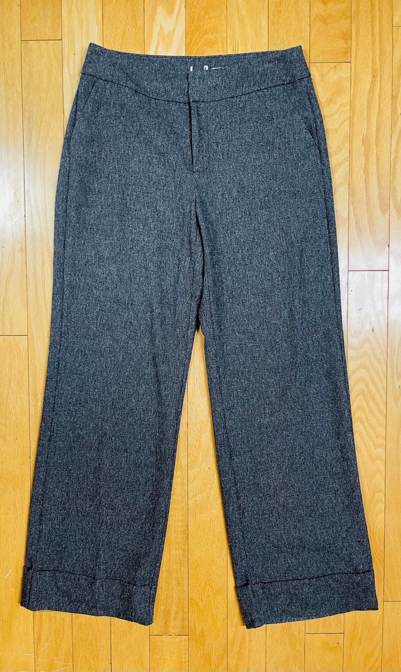 May include: Gray wide-leg pants with a cuffed hem.