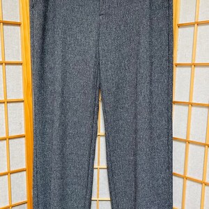 May include: Gray wide-leg pants with a cuffed hem. The pants have a straight leg and a mid-rise waist.