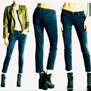 May include: Three images of dark wash denim jeans. The jeans are styled with a green leather jacket, a striped roll neck, and green lace-up boots. The jeans have a classic five-pocket design and a straight leg fit.
