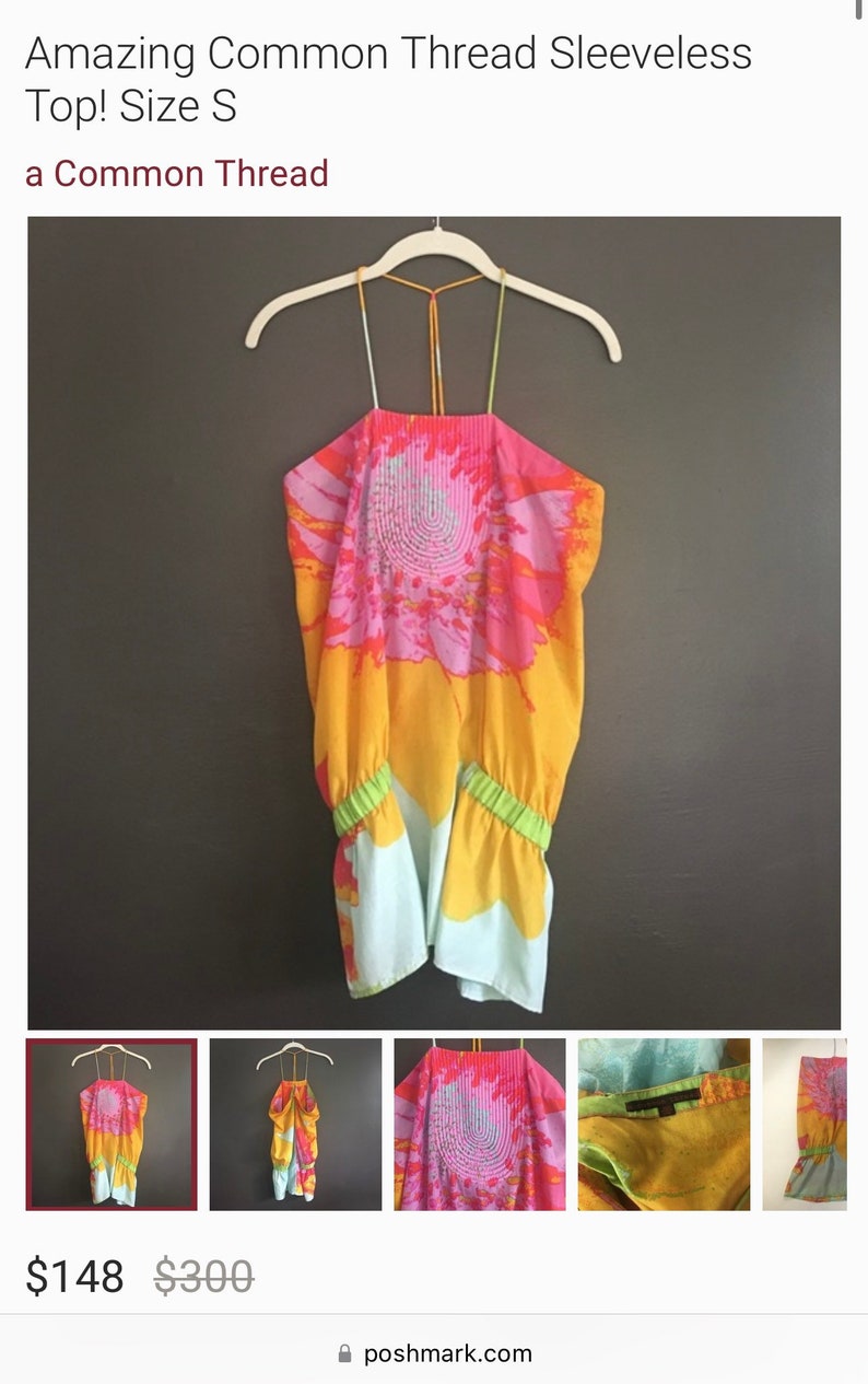 May include: A sleeveless halter top with a colorful abstract print in shades of pink, orange, and yellow. The top has a green elastic band at the bottom.
