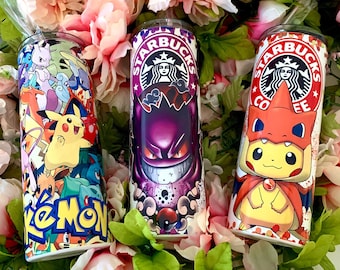 May include: Three stainless steel tumblers with different designs. The first tumbler features a colorful Pokemon design with the word "Pokemon" in large letters. The second tumbler features a purple and black design with the Starbucks logo and the words "Starbucks Coffee". The third tumbler features a yellow and orange design with a Pikachu character and the Starbucks logo and the words "Starbucks Coffee".