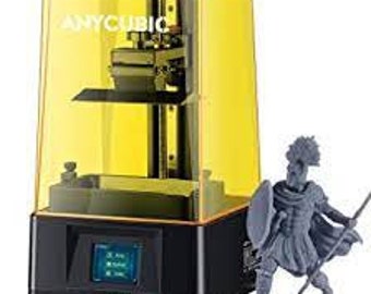 May include: A yellow 3D printer with a clear plastic enclosure. The printer is on a black base with a small LCD screen. A gray 3D printed figurine of a warrior is standing next to the printer.