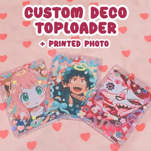 May include: Three clear plastic toploaders decorated with colorful stickers and charms, each containing a printed anime character photo. The text CUSTOM DECO TOPLOADER + PRINTED PHOTO is displayed above the items on a pink heart background.