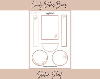 May include: A sticker sheet with various shapes and sizes, including rectangles, circles, and half-circles, in shades of beige and brown. The sheet is labeled "Comfy Vibes Boxes" and "Sticker Sheet" in cursive script. Decorative floral elements are included.