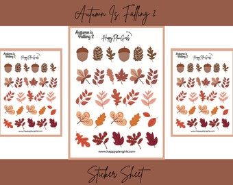 May include: Sticker sheets featuring autumn-themed illustrations. The stickers include acorns, pinecones, and various leaf designs in shades of brown, orange, and red. The text "Autumn Is Falling 2" and "Happy Plan Girls" are visible.