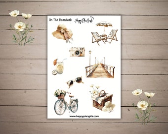 May include: A set of watercolor stickers featuring a beach theme. The stickers include a beach umbrella, beach chairs, a camera, a coconut drink, sunglasses, a bicycle with a basket of flowers, a picnic basket, and a boardwalk.