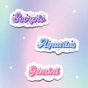 May include: Three colorful zodiac sign stickers with a sparkly background. The stickers feature the words "Scorpio", "Aquarius", and "Gemini" in a retro font.