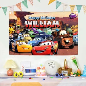 May include: A colorful birthday banner featuring characters from the movie Cars, with the text "Happy Birthday William". The banner includes images of Lightning McQueen, Mater, and other animated cars, with a desert landscape background.
