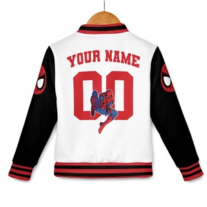 May include: White and black letterman jacket with red accents. The back features the text "YOUR NAME" above the number "00" and a Spider-Man graphic. The sleeves have a Spider-Man logo.