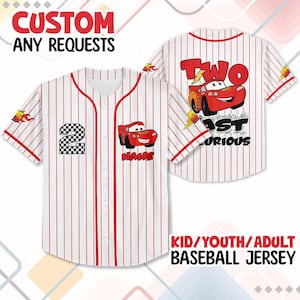 May include: White baseball jersey with red pinstripes, featuring a cartoon car graphic and the text "TWO FAST CURIOUS". The jersey has the number "2" and the word "NAME" on the front. The text "CUSTOM ANY REQUESTS" is at the top.