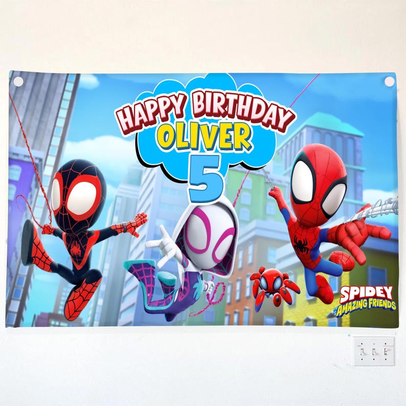 May include: A rectangular birthday banner featuring the text Happy Birthday Oliver 5 and Spidey and His Amazing Friends characters including Spider-Man, Ghost-Spider, and Spin against a city skyline background with blue and red colors.
