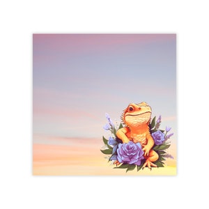 May include: A bearded dragon lizard sits in a bed of purple flowers with green leaves against a pink and orange sunset sky.