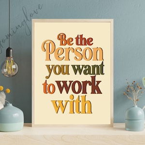 May include: A motivational quote in a retro style font on a beige background. The quote reads "Be the Person you want to work with".