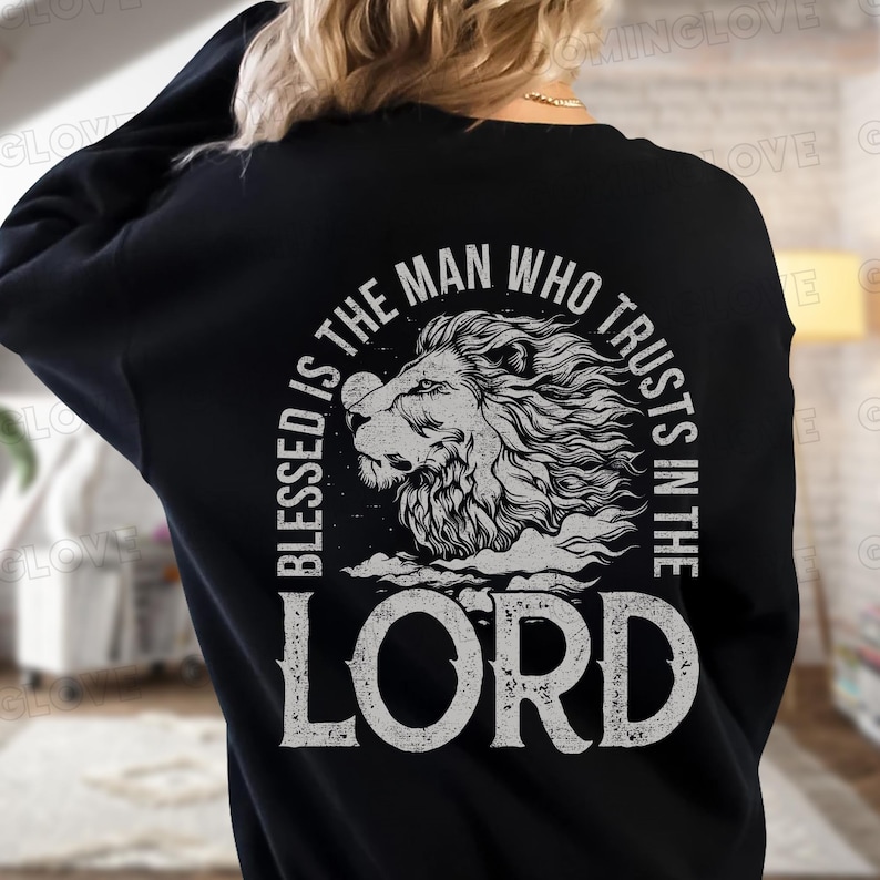 May include: Black sweatshirt with a white graphic design of a lion's head with the text "Blessed is the man who trusts in the Lord".
