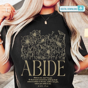 May include: Black t-shirt featuring a floral design and the word "ABIDE" in a gold color. The shirt also includes the Bible verse John 15:4. The words "DIGITAL DOWNLOAD" are in the upper right corner.