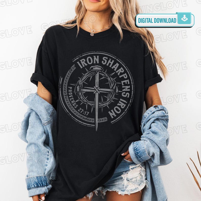 May include: Black t-shirt with a circular graphic featuring a cross, thorns, and the text "IRON SHARPENS IRON" and "PROVERBS 27:17". The shirt is worn with a denim jacket and shorts.