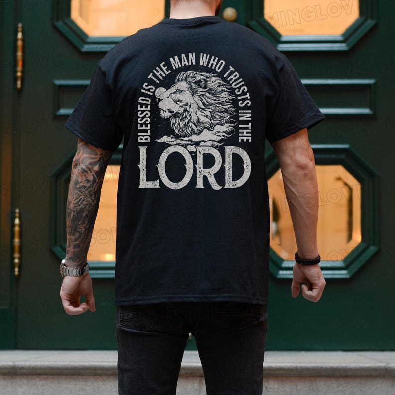 May include: Black t-shirt with a white graphic design featuring a lion and the text "Blessed is the man who trusts in the Lord".