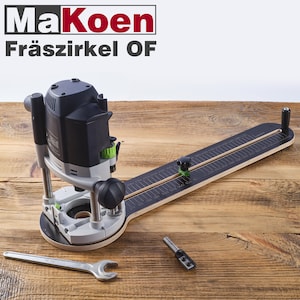 Op de afbeelding: Een zwarte en groene freesmal met een houten basis en een liniaal die in centimeters is gemarkeerd. De mal wordt gebruikt om cirkels en andere vormen met een frees te maken.