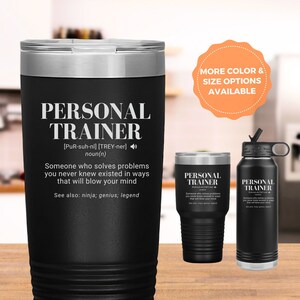 May include: Black stainless steel tumbler with a white inscription that reads "PERSONAL TRAINER [PuR-suh-nl] [TREY-ner] noun(n) Someone who solves problems you never knew existed in ways that will blow your mind See also: ninja; genius; legend".