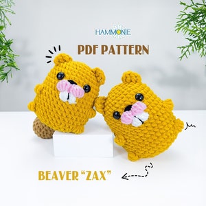 May include: Two crocheted beaver amigurumi toys in a yellow color. The toys have black eyes, pink noses, and white teeth. The text "BEAVER "ZAX" " is visible at the bottom of the image. The text "PDF PATTERN" is visible at the top of the image.