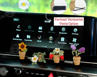 May include: Crocheted car vent decorations in the shape of potted flowers, including a sunflower, a daisy, a strawberry plant, and a purple flower. The decorations are in small woven pots and have a neutral color scheme. The image also shows the option for vertical or horizontal vents.