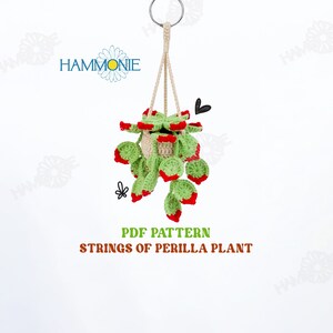 May include: PDF pattern for crocheting a hanging string of perilla plant. The plant is green with red accents and is in a cream-colored pot.
