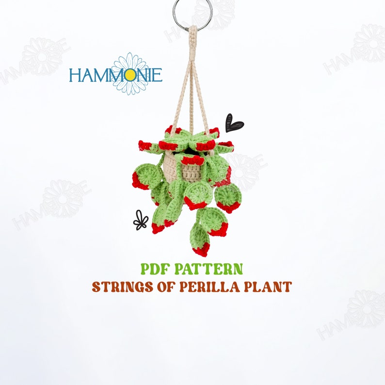 May include: PDF pattern for crocheting a hanging string of perilla plant. The plant is green with red accents and is in a cream-colored pot.