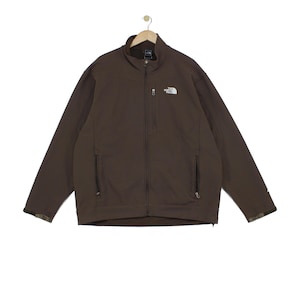 May include: A brown long-sleeve jacket with a full-length front zip, a high collar, and two zipped hand pockets. The North Face logo is embroidered in white on the upper left chest, and there is an additional vertical zipped chest pocket.