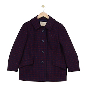 May include: A dark navy blue and red speckled wool-blend coat featuring a classic collar, long sleeves, and a front button closure with four dark buttons. The garment includes two front flap pockets and a Pendleton brand label at the neckline.