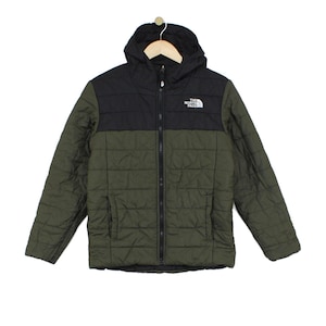 May include: A quilted jacket featuring a black upper section and an olive green lower section. The jacket includes a hood, a full-length front zip, and the white The North Face logo embroidered on the upper left chest. The design is insulated.
