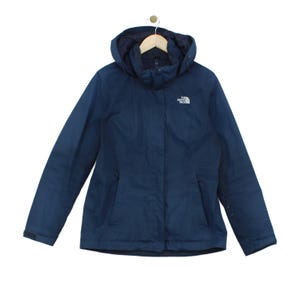 May include: A dark blue hooded jacket featuring a high collar, a front zip closure with a protective flap, and long sleeves with adjustable cuffs. The North Face logo is embroidered in white on the upper left chest area of the garment.