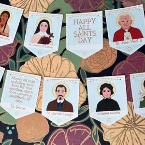 May include: A banner with illustrations of saints, including St. John Paul II, St. Peter, and St. Elizabeth Ann Seton. The banner also includes the text "Happy All Saints Day" and inspirational quotes. The background is a floral pattern.