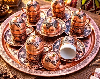 May include: A set of copper coffee cups with lids and matching saucers arranged on a large round copper tray. Each cup and lid features intricate black etched patterns. One cup is shown without its lid, revealing a white interior ceramic lining.