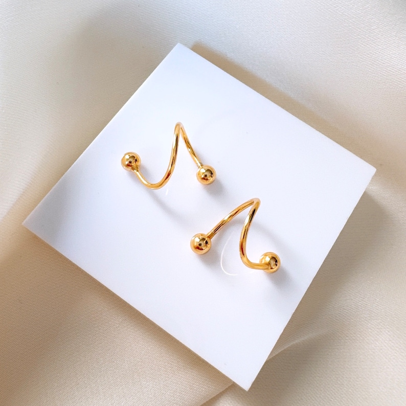 Gold spiral earrings for helix and earlobe